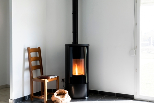 Modern,Black,Stove,With,Burning,Flames,And,Pellet,Bag,In